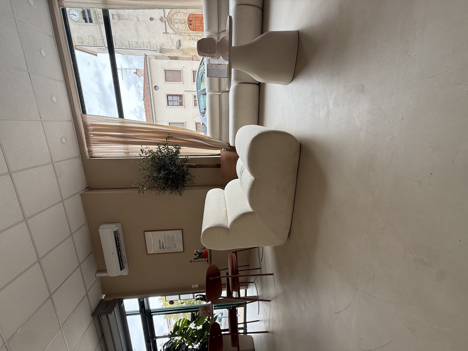 Espace professionnel aménagé avec assises et grande baie sur rue